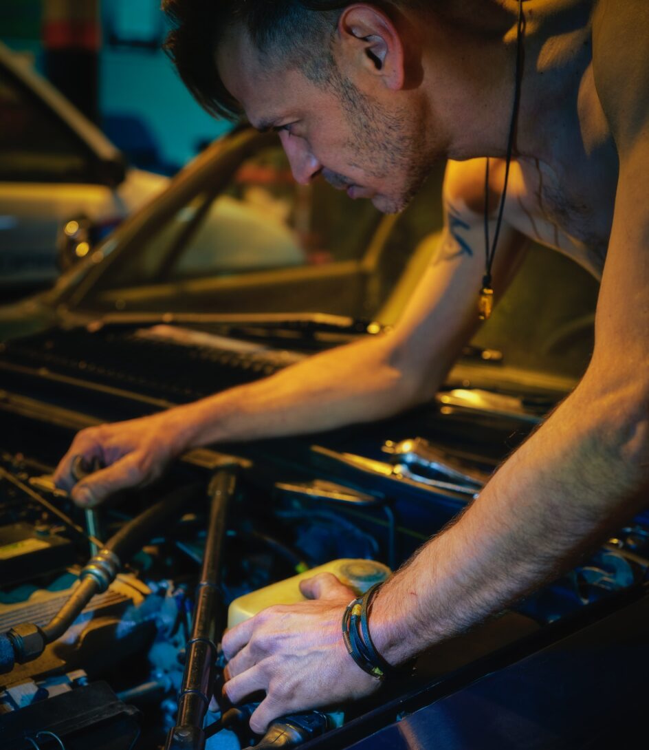 man repairing a car