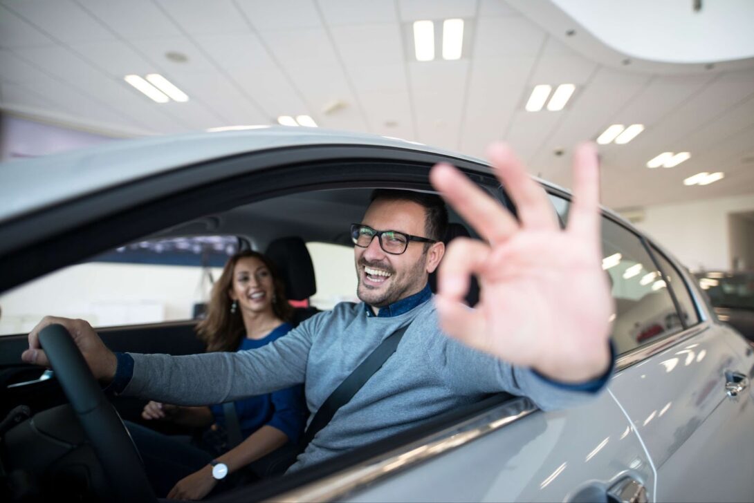 Happy people are sitting in the car